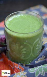 Pretty vertical picture of an apple carrot kale green smoothie.
