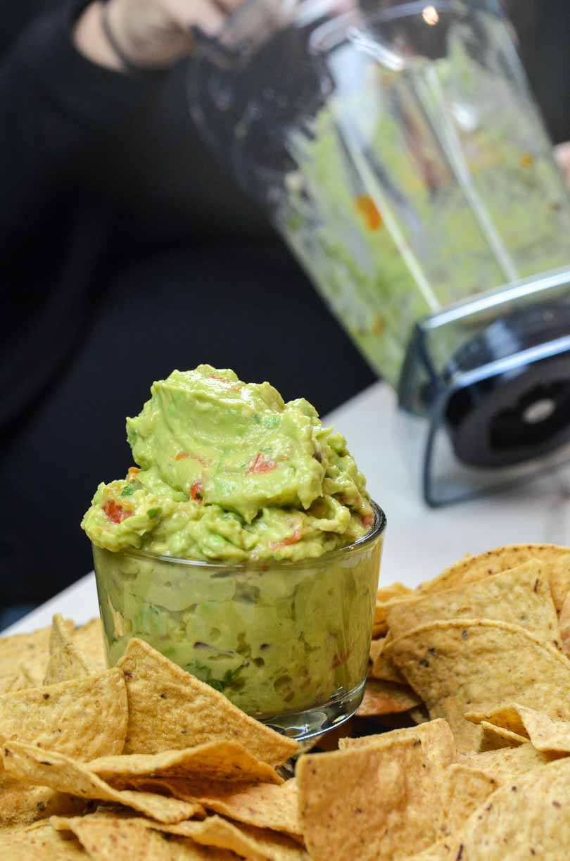 Guacamole scooped from a Vitamix container.