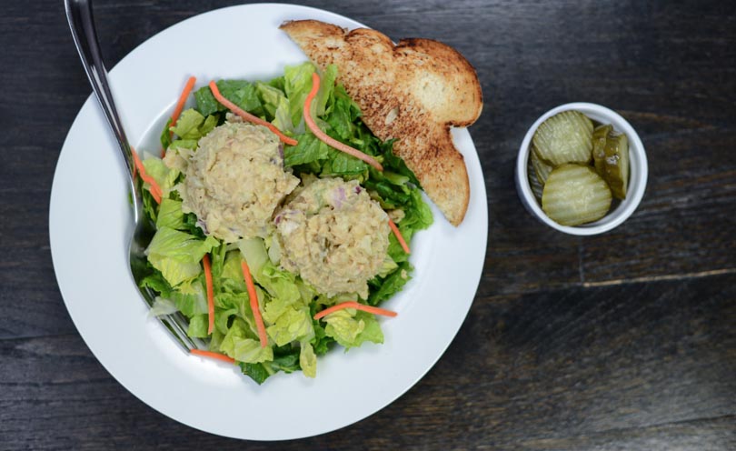Vegan tuna salad made in a Vitamix served over greens.