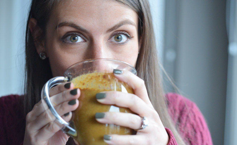 Shalva drinking a pumpkin spice latte made in a Vitamix.