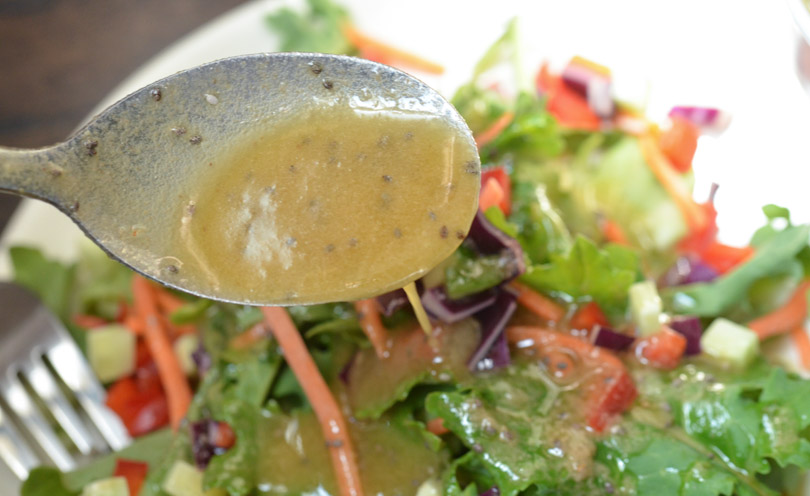 Spoonful of chia seed dressing made in a Vitamix.