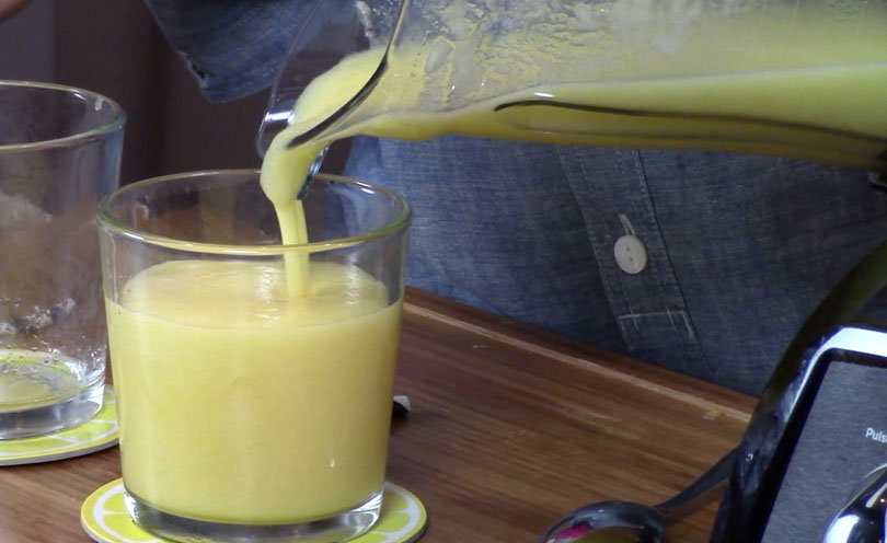 Pouring daiquiri from Vitamix into cup.