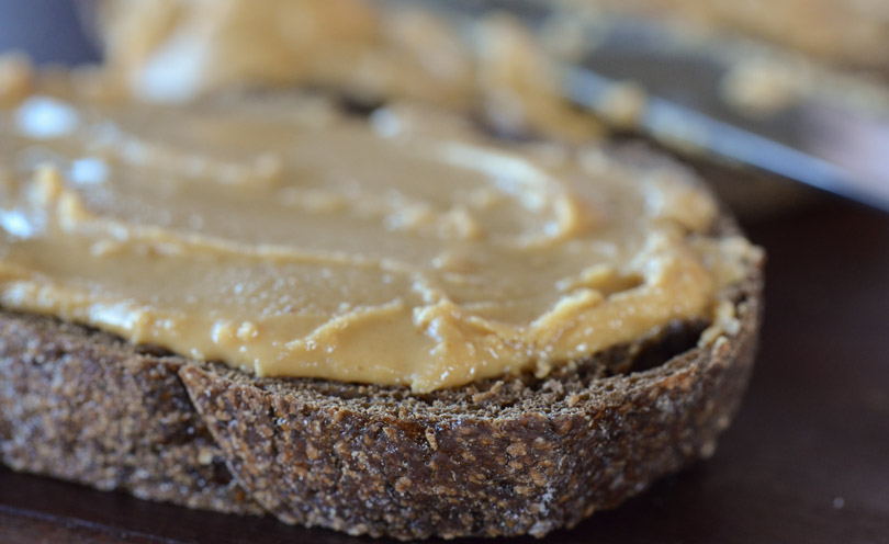 Vitamix-made peanut butter on a piece of pumpernickel bread.