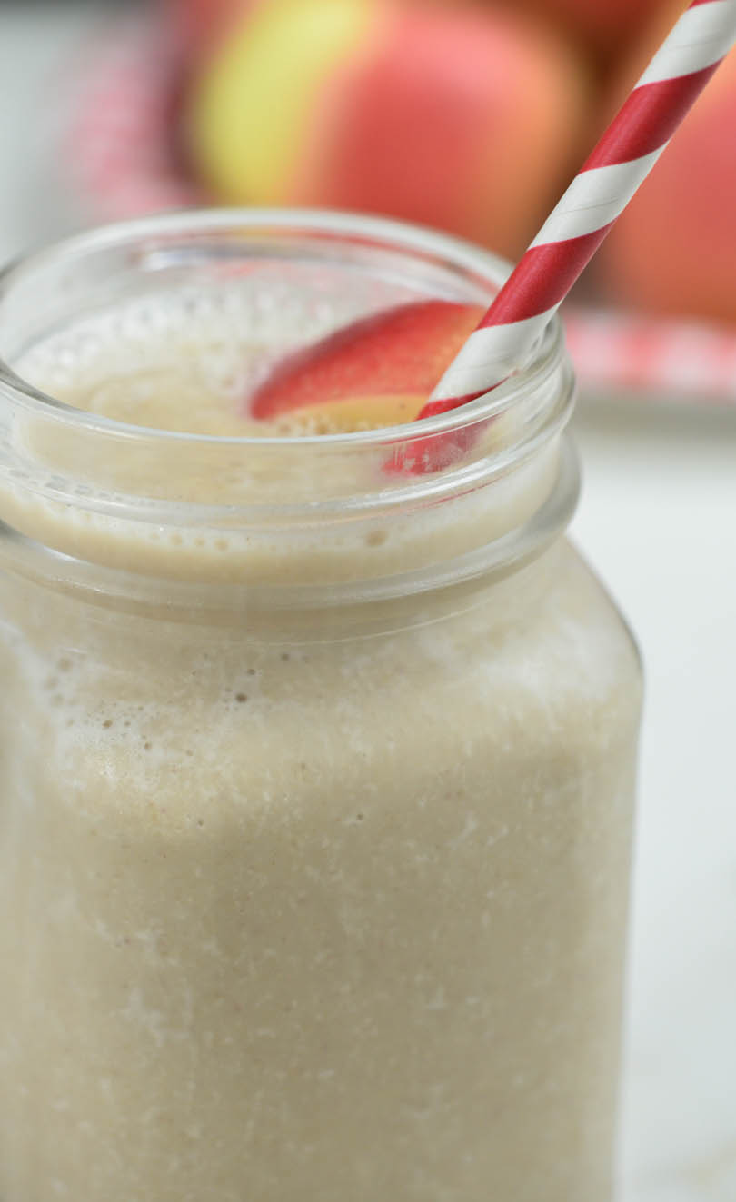 Apple pie smoothie with a red striped straw.