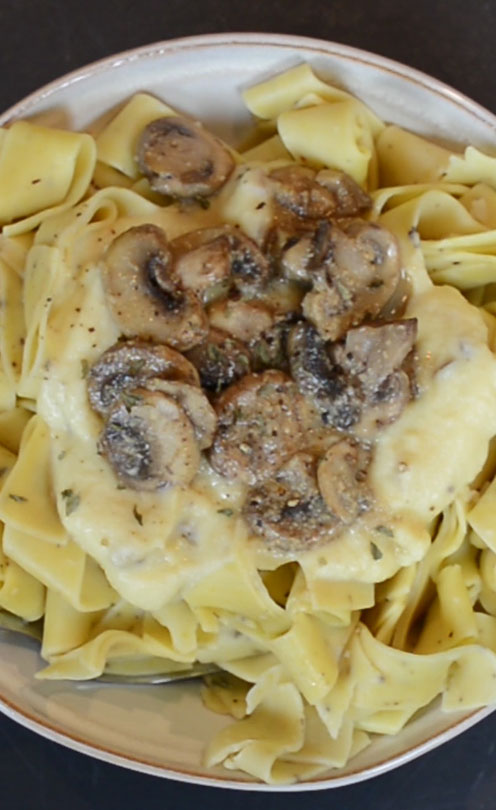 Birdseye view of alfredo sauce over pasta.