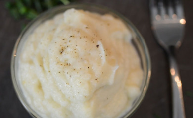 Cauliflower mash potatoes served with chives on the side.