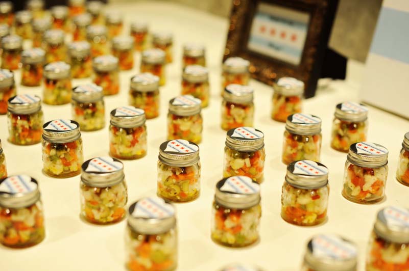 small jars of Giardiniera on wedding gift table for guests