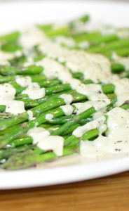Vegan hollandaise sauce spread over asparagus.
