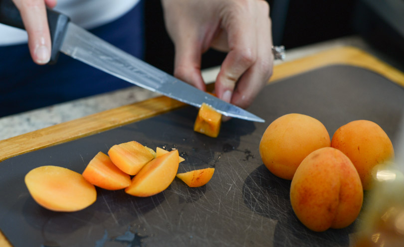 Up close pic of cutting apricots.