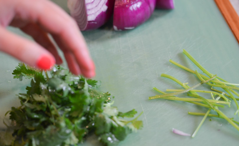 Removing stems from cilantro.