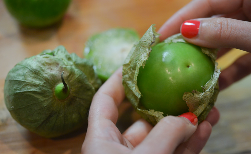 Peeling the tomatillos by hand.