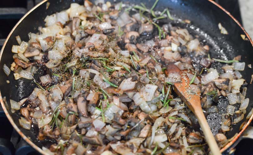 Mushrooms and onions sauteeing.
