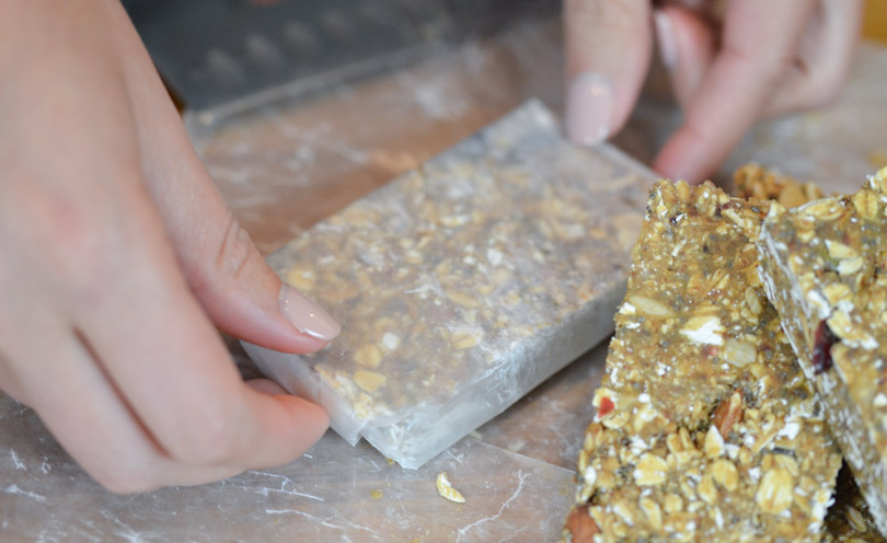 Wrapping super seedy granola bars in parchment paper.