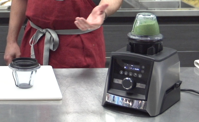 An 8 ounce container on top of a Vitamix Ascent 3500.