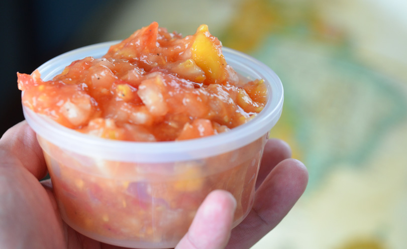 Life is NOYOKE's Hawaiian salsa held up in small container.