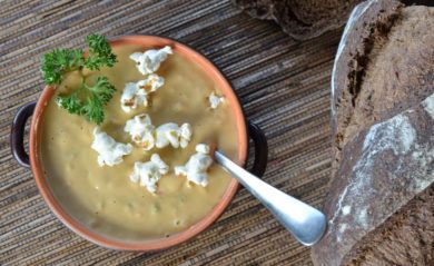 Vegan beer cheese soup with popcorn on top made in a Vitamix.