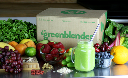 Green Blender smoothie delivery box with fruit and green smoothie.