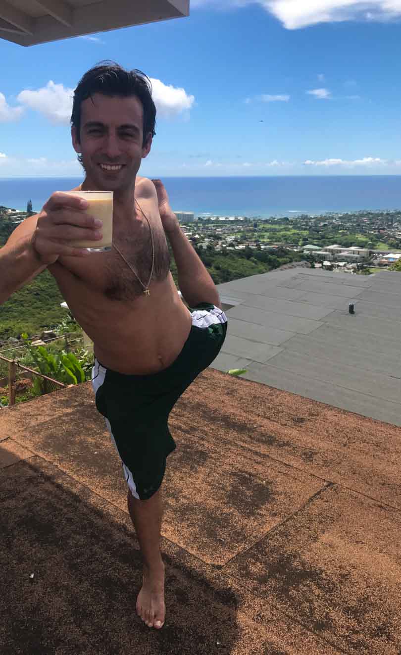 Lenny Gale doing yoga and drinking the Peach Pose smoothie.