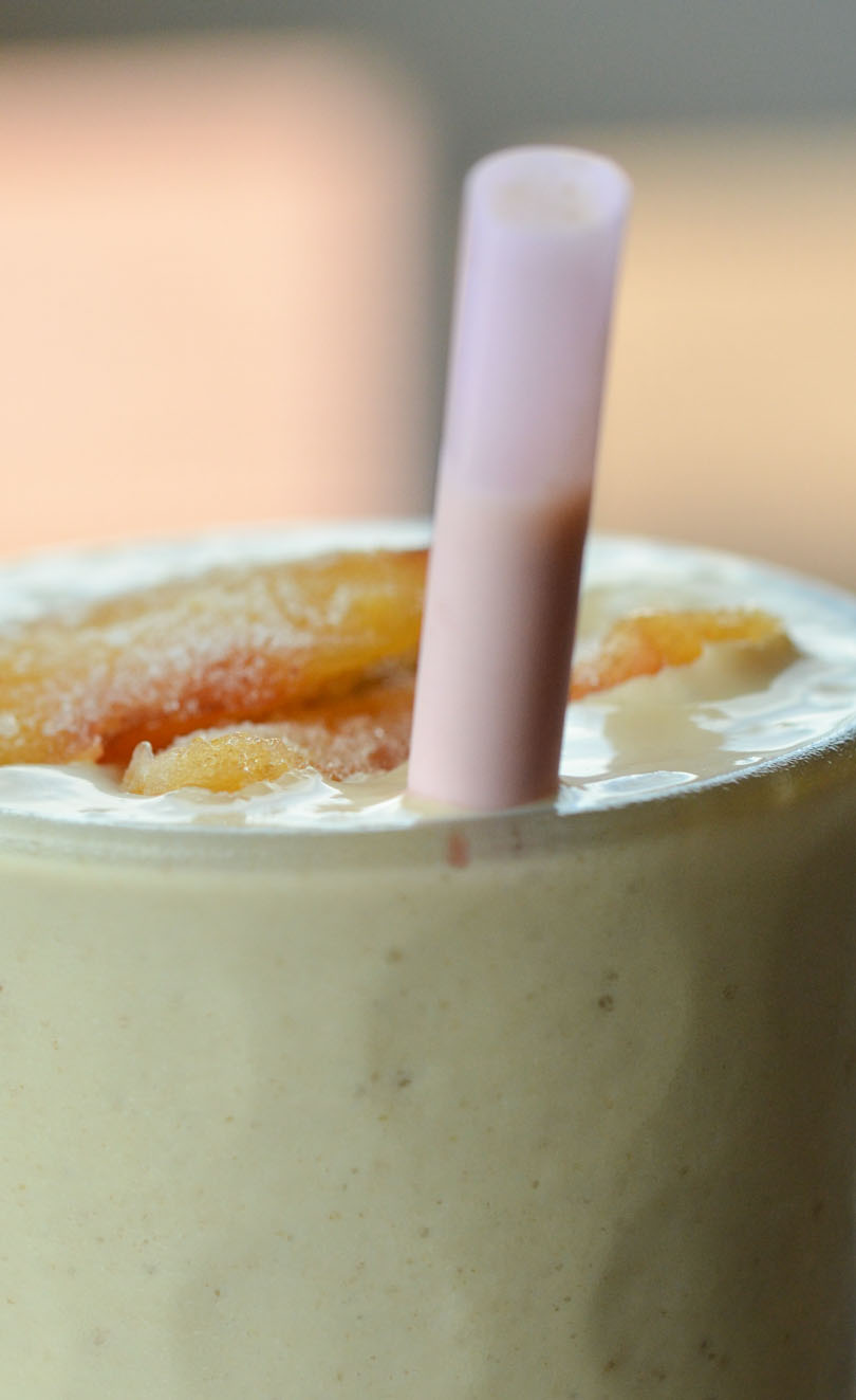 Peach pose smoothie from Life is NOYOKE served with a pink straw.