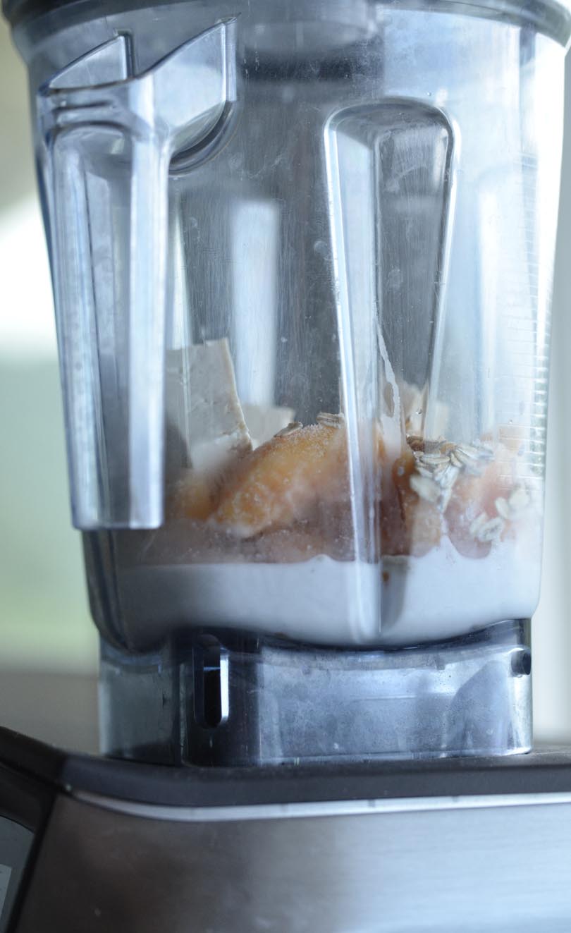 Peach pose smoothie ingredients in a Vitamix A3500.