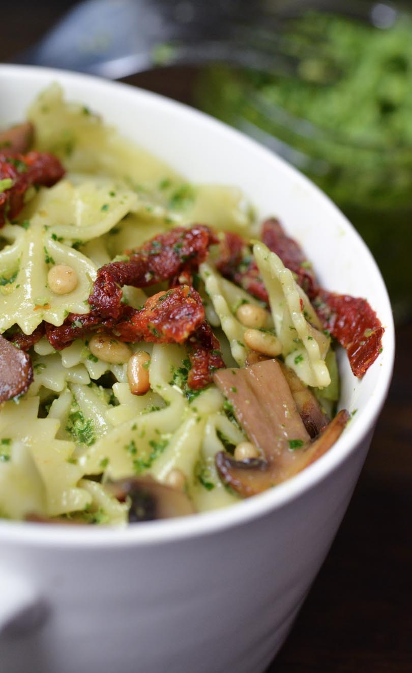 Pesto-covered pasta with sun-dried tomato and mushrooms.