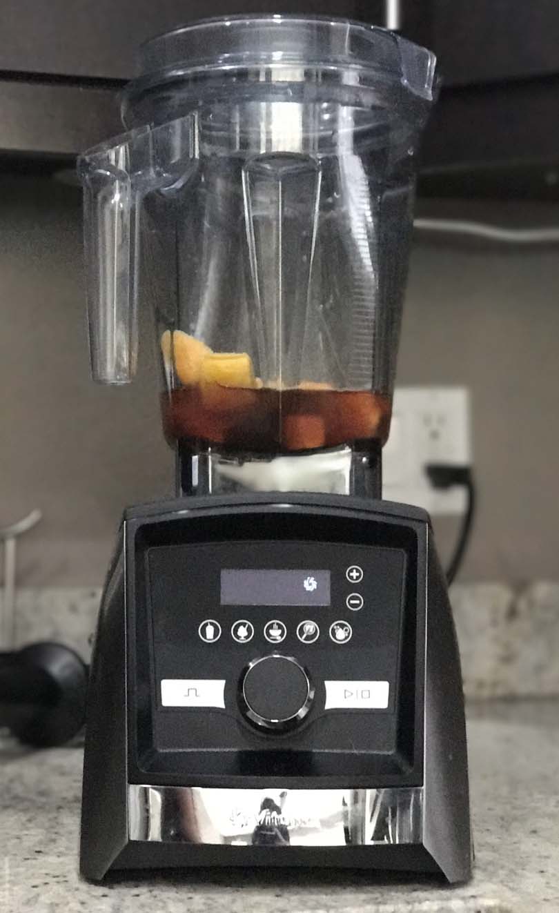 Vitamix A3500 with small batch of black tea mango smoothie ingredients.