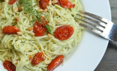 Avocado dill sauce tossed into spaghetti with cherry tomatoes.
