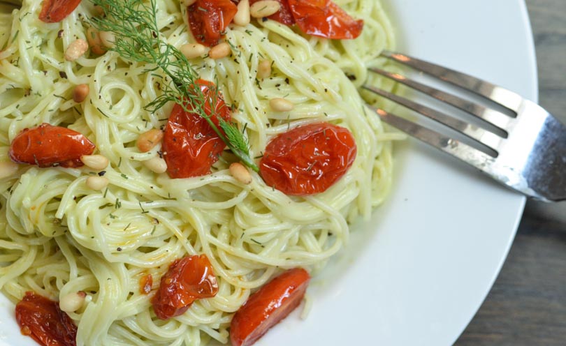 Avocado dill sauce tossed into spaghetti with cherry tomatoes.