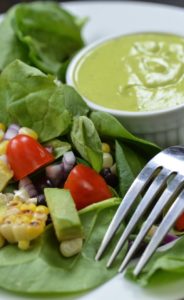 Mango dressing on a spinach salad with roasted corn.