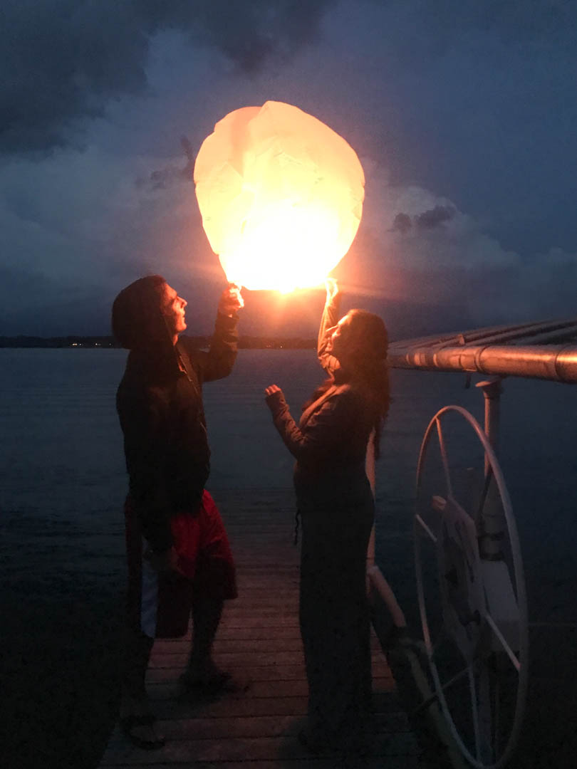 Lenny and Shalva with a wish lantern at the lake in 2017.