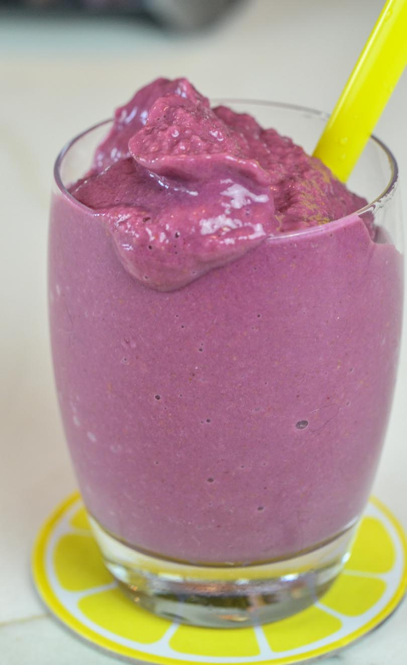 Raspberry lemonade smoothie made in our Vitamix with a yellow straw.