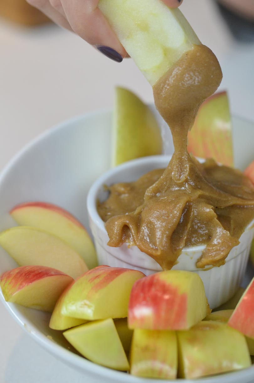 Dipping a slice of apple into caramel dip.