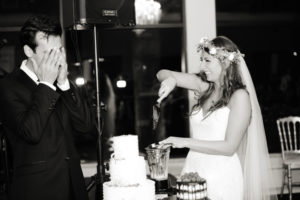 Lenny covering his eyes as Shalva serves a Vitamix'd wedding cake slice.