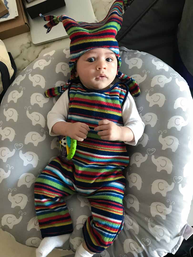 Baby colorful and striped clothing and hat.