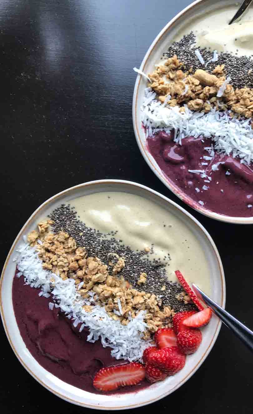 Side-by-side, two flavor smoothie bowls.