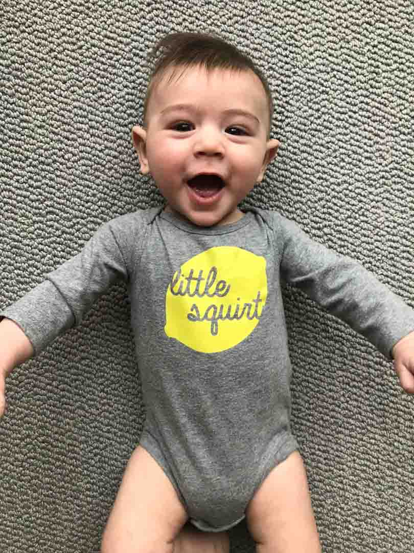 Baby with little squirt lemon shirt.