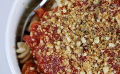 vegan parmesan over pasta with red sauce