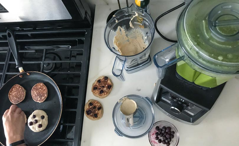 Secondary narrow Vitamix container with low-profile 64-ounce making pancakes and green juice.