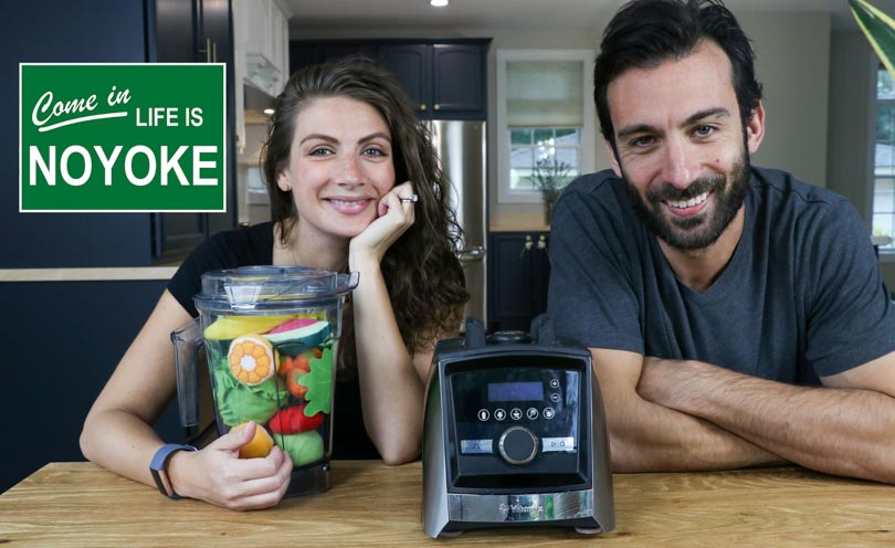 shalva and lenny gale with a vitamix and sign that says come in life is noyoke 