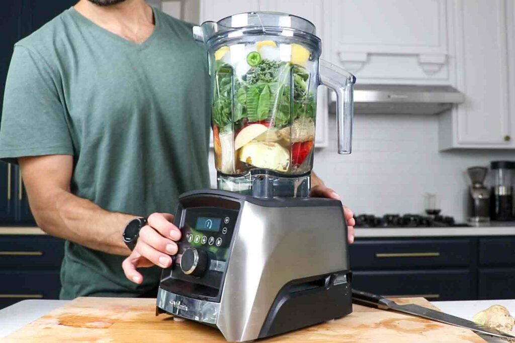 a green smoothie being blended in a vitamix a3500 blender